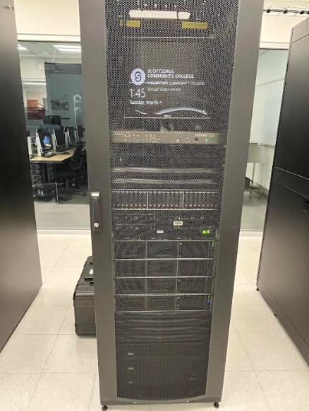 A computer server in the server room. A small screen reads "Scottsdale Community College" with the SCC logo.