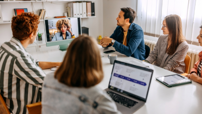 co-workers collaborating in a meeting which is virtual and in-person.