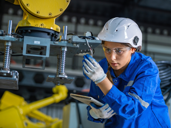 Female engineering tech working on a piece of equipment